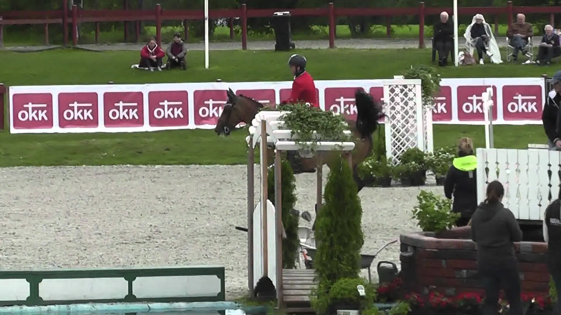 Show jumper clearing a fence in an international arena